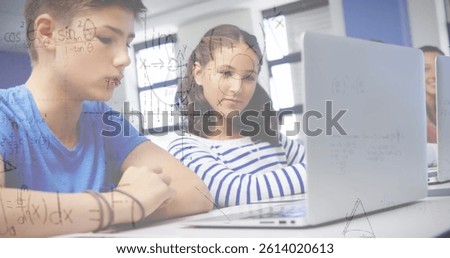 Image of mathematical equations over school children using laptop in classroom. education, learning and technology concept digitally generated image.