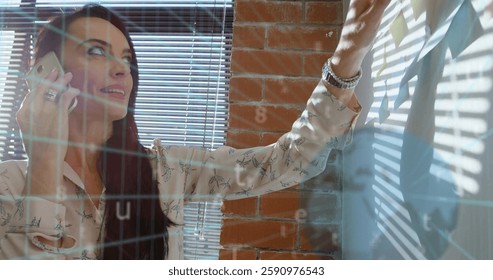 Image of media icons and data processing over caucasian casual businesswoman using smartphone. Global business and digital interface concept digitally generated image.