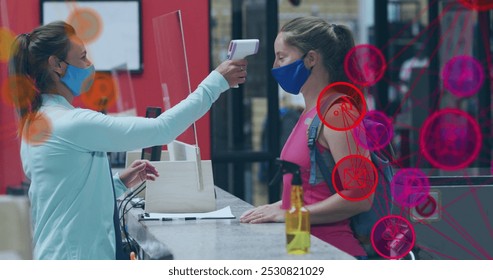 Image of media icons over caucasian female worker with face mask taking temperature. social media and communication interface during covid 19 pandemic concept digitally generated image. - Powered by Shutterstock