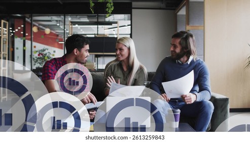 Image of media icons over diverse business people smiling and using laptop. global networks, business, data processing and digital interface concept digitally generated image.