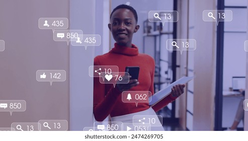 Image of media icons over happy african american businesswoman using smartphone. social media and communication interface concept digitally generated image. - Powered by Shutterstock