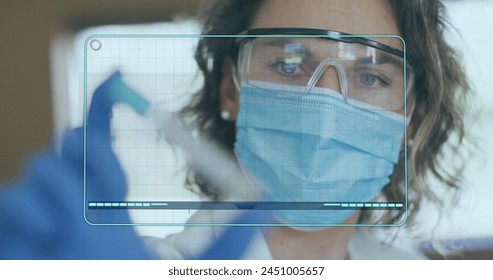 Image of medical data processing on screen over female scientist holding test tube. global coronavirus pandemic, medicine and healthcare concept digitally generated image.