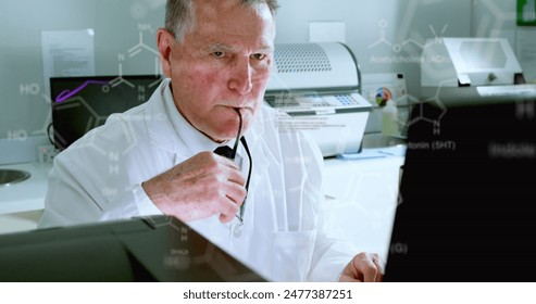 Image of medical data processing on caucasian senior male scientist using computer at laboratory. Medical research and science technology concept