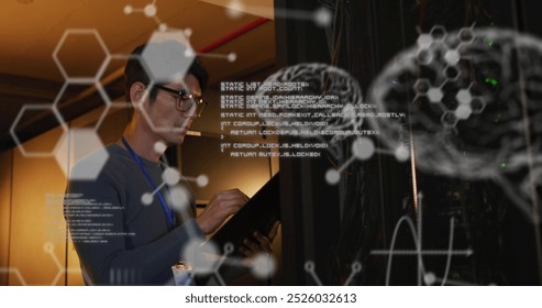 Image of medical data processing over asian male engineer writing on clipboard at server room. Research science and business data storage technology concept - Powered by Shutterstock