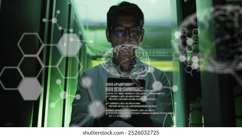 Image of medical data processing over asian male engineer using digital tablet at server room. Research science and business data storage technology concept - Powered by Shutterstock