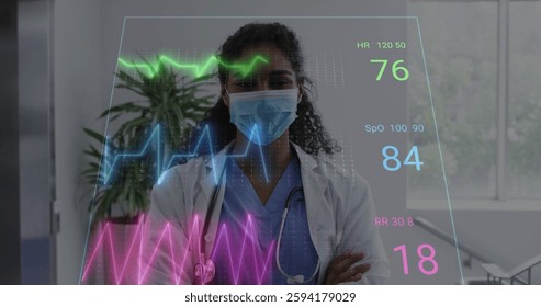 Image of medical data processing over biracial female doctor in face mask. Global medicine, connections, computing and data processing concept digitally generated image.