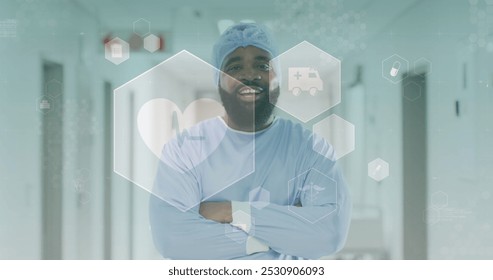 Image of medical icons over portrait of smiling african american male doctor in corridor. Medical and healthcare services concept digitally generated image. - Powered by Shutterstock