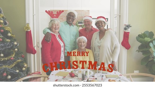 Image of merry christmas text over senior diverse friends smiling. Christmas, celebration and digital interface concept digitally generated image. - Powered by Shutterstock