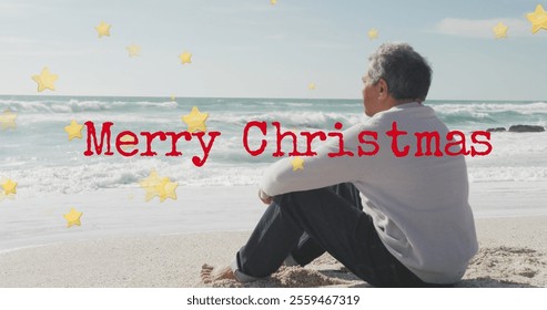 Image of merry christmas text over senior biracial man at beach. Christmas, celebration and digital interface concept digitally generated image. - Powered by Shutterstock