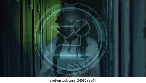 Image of message block icon over african american female engineer using tablet at server room. Cyber security and business data storage technology concept