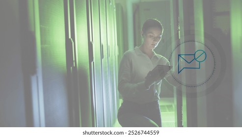 Image of message block icon over caucasian female engineer using digital tablet at server room. Cyber security and business data storage technology concept