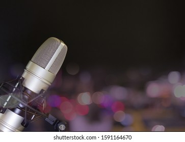 Image Of A Microphone For Recording, Singing Or Speaking  With Bokeh As The Background And Copy Space Available For You To Edit.