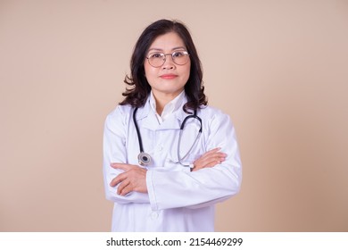 Image of middle aged Asian female doctor on background - Powered by Shutterstock