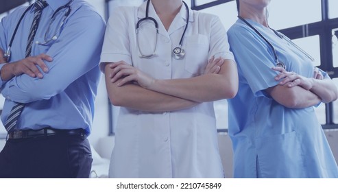 Image of midsection of diverse male and female doctors with arms crossed. Medicine and healthcare concept. - Powered by Shutterstock