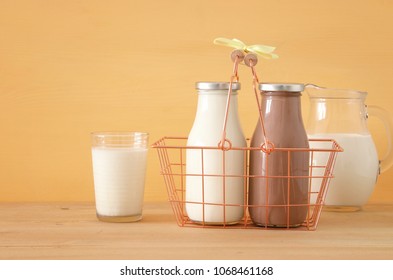 image of milk and chocolate over wooden table. Symbols of jewish holiday - Shavuot