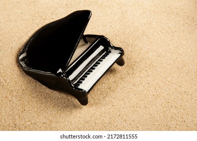 image of miniature piano sand background 