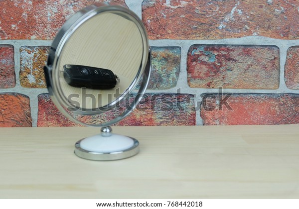 The image\
of mirror with car key, reflected in\
it