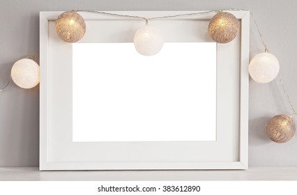 Image Of A Mockup Scene With White Landscape Frame With Baubles. 