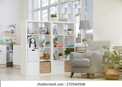 Image of modern domestic room with armchair and bookcase in the house