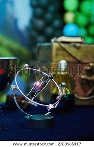 The image of a molecule in the form of a perpetual motion machine on a magnet. The concept of science and education.
