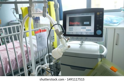 An Image Of Monitor Screen Of Respiratory Ventilator,Ventilation Machine Along Side With Empty Bed And Medical Equipments At Intensive Care Unit (ICU) In Hospital For Helping Critically ARDS Patients