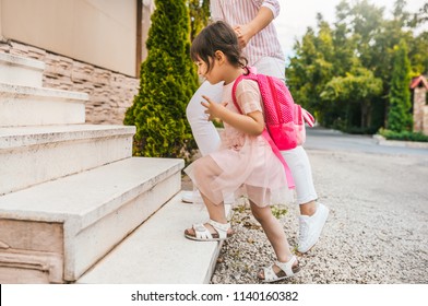 Image Of Mother And Pupil Daughter Going Back At Home From Kindergarten. Good Relationship. Happy Cute Little Girl With Her Mom Feel Happy After The Preschool Day, Climb Up The Stairs At Home Outside