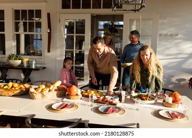 Image of multi generation caucasian family preparing outdoor dinner. Family and spending quality time together concept.