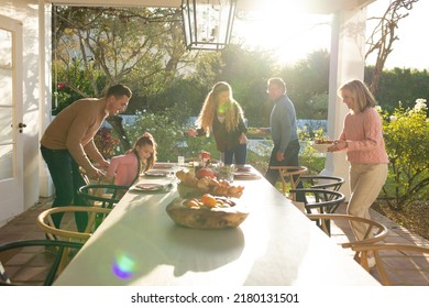 Image of multi generation caucasian family preparing outdoor dinner. Family and spending quality time together concept.