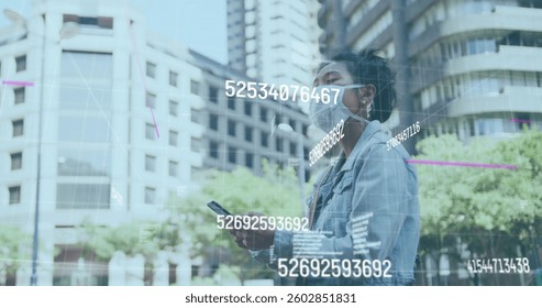 Image of multiple changing numbers floating against woman wearing face mask using smartphone. coronavirus covid 19 pandemic concept