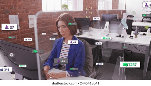 Image of multiple notification bars over asian woman working on computer in office. Digital composite, multiple exposure, business, social media reminder and technology concept.