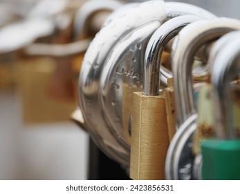 Image of multiple padlocks attached on to the Brooklyn Bridge.