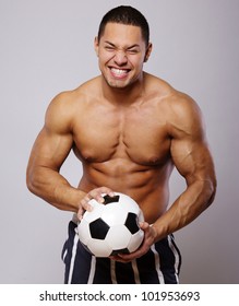 Image of muscle man posing in studio with ball