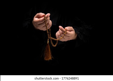 The image of a Muslim woman's hand, Islamic prayer, and her hand holding a rosary beads or tasbih. - Powered by Shutterstock