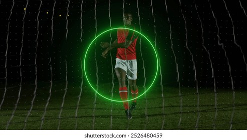 Image of neon geometrical shapes rotating over african american male soccer player. Sport, competition and movement concept digitally generated image. - Powered by Shutterstock