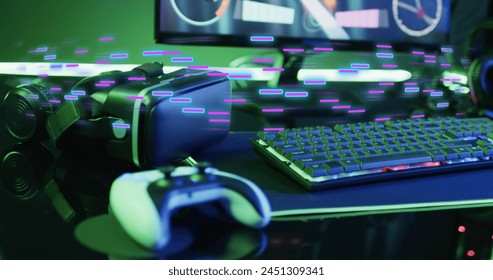 Image of neon light trails over image game computer equipment. Global image game, digital interface, data processing and connections concept digitally generated image.