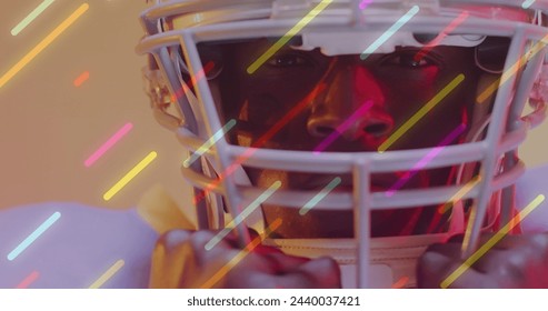 Image of neon lines over american football player on neon background. Sports, competition and communication concept digitally generated image. - Powered by Shutterstock