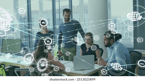 Image of network of connections with icons over diverse colleagues using laptop in office. Technology, business and digital interface concept digitally generated image. - Powered by Shutterstock