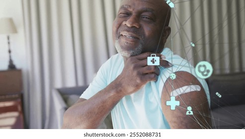 Image of network of connections with icons over senior african american man. Global medicine, healthcare, connections and digital interface concept digitally generated image. - Powered by Shutterstock