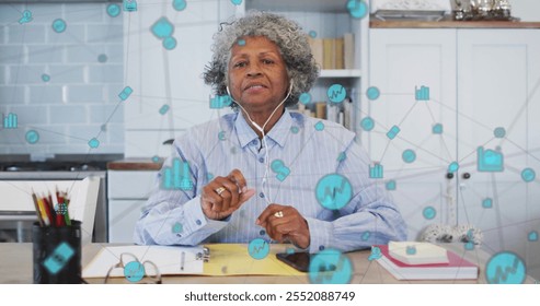 Image of network of connections with icons over senior african american woman having image call. Global lifestyle, connections and digital interface concept digitally generated image. - Powered by Shutterstock