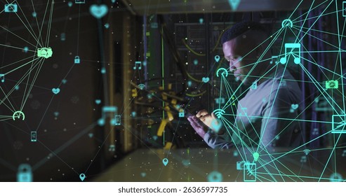 Image of network of connections with icons over african american male server room using tablet. Cloud computing concept digitally generated image.