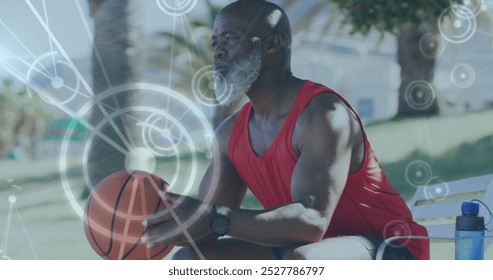 Image of network of connections over senior african american man with basketball at beach. healthy, active lifestyle, connections and digital interface concept digitally generated image. - Powered by Shutterstock