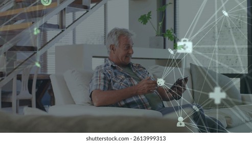 Image of network of connections over senior caucasian man using tablet. global connections, digital interface and technology concept digitally generated image.