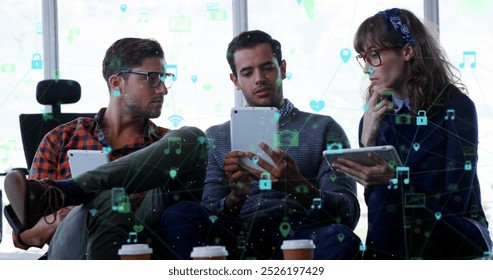 Image of network of digital icons against diverse group of colleagues discussing at office. Global networking and business technology concept - Powered by Shutterstock