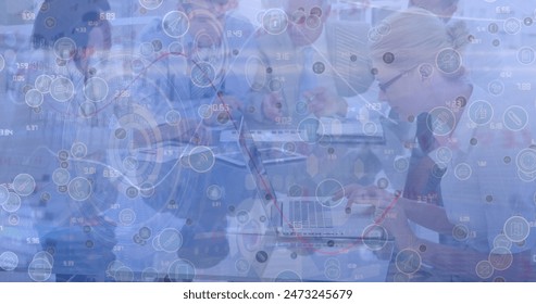 Image of network of digital icons over diverse colleagues discussing together at office. Computer interface and business technology concept - Powered by Shutterstock