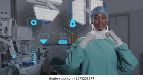 Image of network medical icons over african american female surgeon smiling in theatre. Surgery, digital interface, connection, hospital and healthcare, digitally generated image.