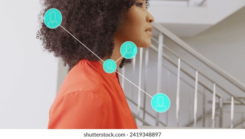 Image of networks and data processing over african american businesswoman in office. Global networks, business, finances, computing and data processing concept digitally generated image.