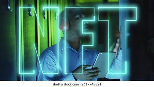 Image of nft text over african american male worker in server room. global business, cloud computing and digital interface concept digitally generated image.