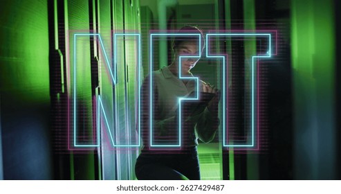Image of nft text over caucasian woman using tablet in server room. Cloud computing, digital interface and security concept digitally generated image.