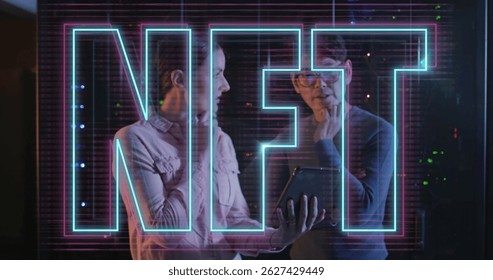 Image of nft text over diverse couple using tablet in server room. Cloud computing, digital interface and security concept digitally generated image.
