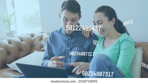 Image of numbers changing over caucasian couple using laptop. Global social media, business, finance and data processing concept digitally generated image.